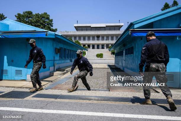 In this photo taken on May 9 South Korean soldiers change positions at the truce village of Panmunjom in the Joint Security Area of the Demilitarized...