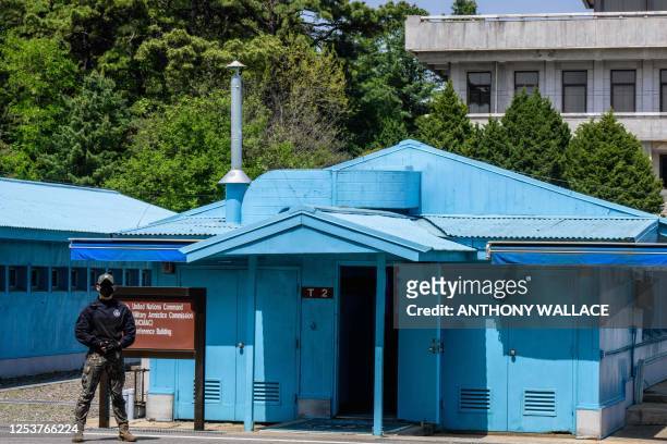 In this photo taken on May 9 a South Korean soldier stands guard outside a conference room at the truce village of Panmunjom in the Joint Security...