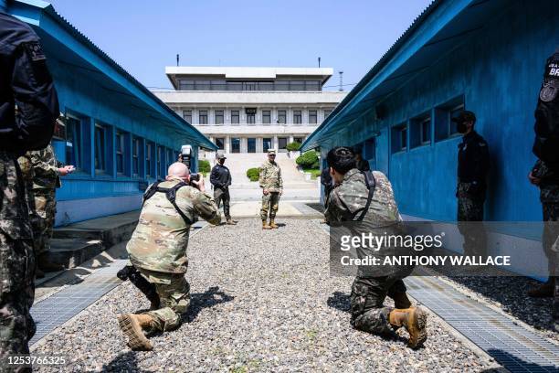 In this photo taken on May 9 US Army Chief of Staff General James McConville poses with a view of North Korea's Panmon Hall as he stands in front of...