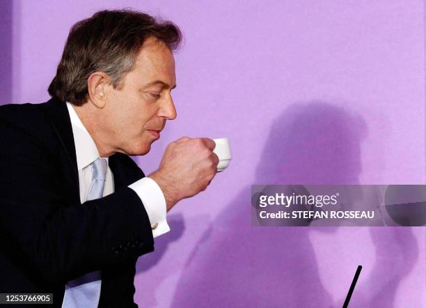 Britain's Prime Minister Tony Blair has a cup of tea during a discussion with health experts about future funding for the NHS at the 'Kings Fund' in...