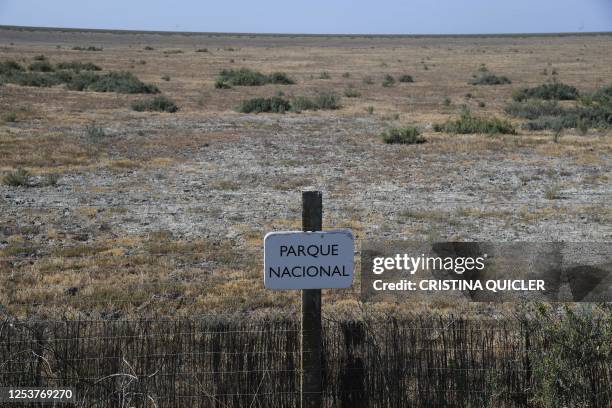 This picture taken on May 11, 2023 shows a sign resdinf "National Park" on a scorched field, at the Donana National Park in Aznalcaraz, southern...