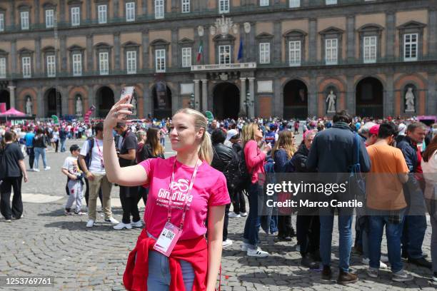 Girl, with a Giro d'Italia t-shirt takes a selfie in Plebiscito square, during the six stage of the 106th Giro d'Italia 2023, 162 km between Naples...