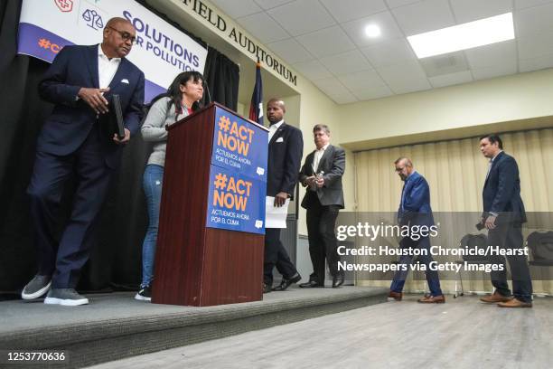 Erandi Treviño, of Moms Clean Air Force, stands at the podium as others, including Rodney Ellis, Harris County Commissioner Precinct 1, left, and...