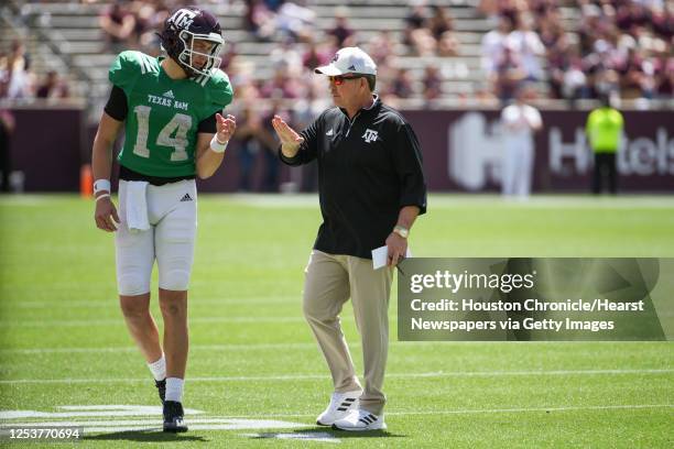 Texas A&M head coach Jimbo Fisher, right, talks to quarterback Max Johnson during the first half of the annual Maroon and White football game at Kyle...