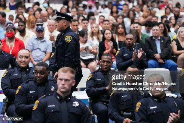 Houston Police cadets applaud as classmates have their badges pinned to their chest during the graduation of Cadet Class 254 at the Houston Police...