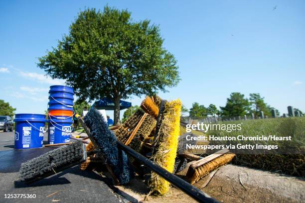 Scrub brushes a piled up near the gravesites as volunteers work on clean-up and maintenance efforts at Houston National Cemetery Saturday, Sept. 10,...