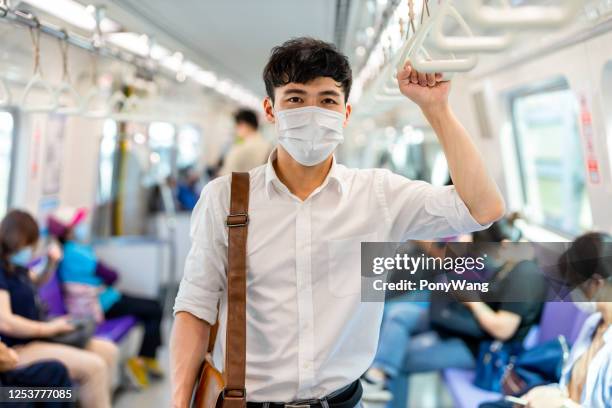 man with mask in metro - commuter mask stock pictures, royalty-free photos & images