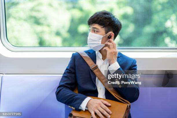 man with mask in mrt - taipei mrt stock pictures, royalty-free photos & images