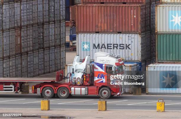 Truck with British Union flag decal next to shipping containers on the dockside at the Port of Felixstowe, owned by a unit of CK Hutchison Holdings...