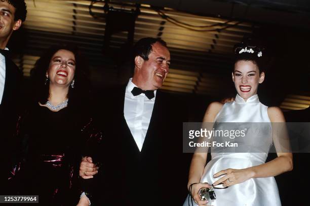 Guest, director Bernardo Bertolucci and Liv Tyler attend the 49th Cannes film Festival in May 1996, in Cannes, France.