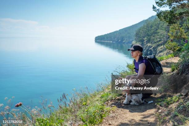 hiking woman with dog - lake baikal stock pictures, royalty-free photos & images