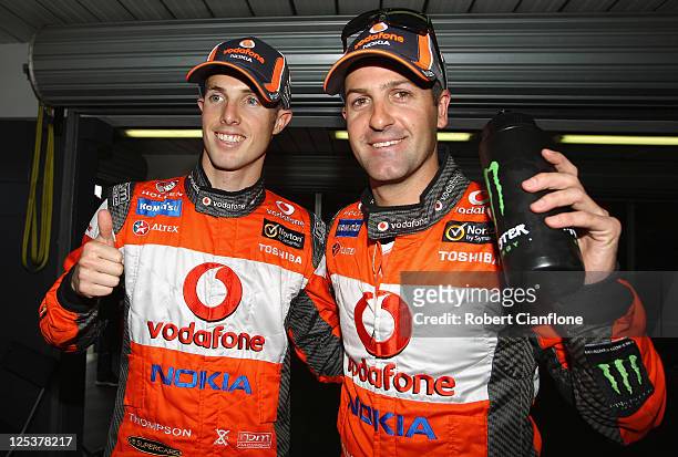 Andrew Thompson and Jamie Whincup, drivers of the Team Vodafone Holde are seen in the pit after taking pole position for the qualifying race during...