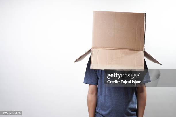 cardboard boxes over faces of men - cardboard stock pictures, royalty-free photos & images