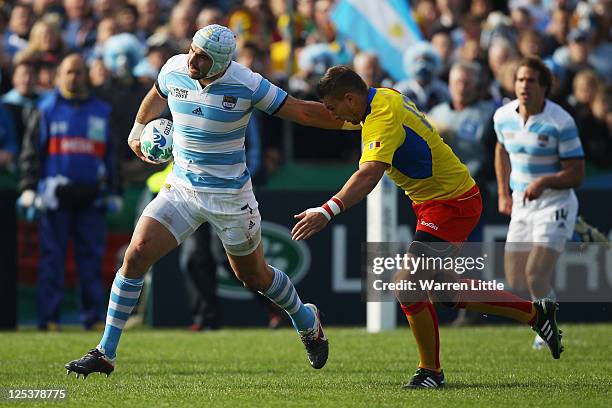 Juan Manuel Leguizamon of Argentina breaks free to score their second try during the IRB 2011 Rugby World Cup Pool B match between Argentina and...