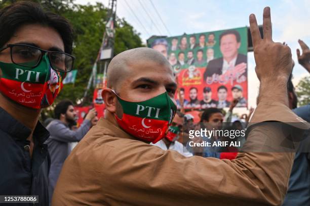 Pakistan Tehreek-e-Insaf party activists and supporters of Pakistan's former Prime Minister Imran Khan celebrate after Supreme Court declared Khan's...