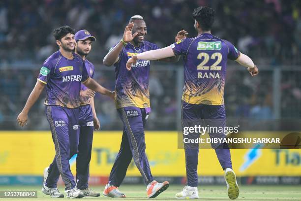 Kolkata Knight Riders' Andre Russell celebrates with teammates after the dismissal of Rajasthan Royals' Jos Buttler during the Indian Premier League...