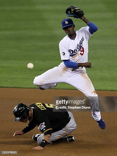 Shortstop Dee Gordon of the Los Angeles Dodgers throws to first after forcing out Ronny Cedeno of the Pittsburgh Pirates to complete a double play...