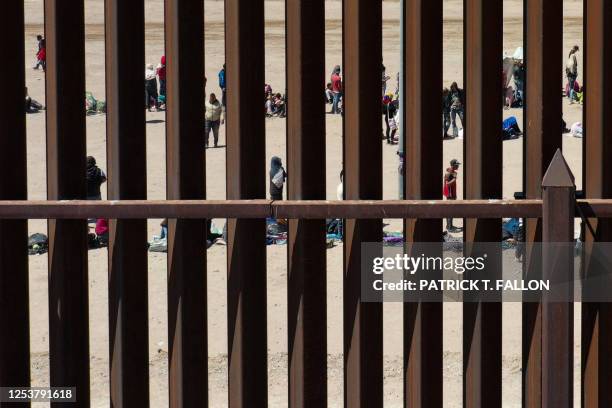 An aerial image shows migrants waiting along the border wall to surrender to US Customs and Border Protection border patrol agents for immigration...