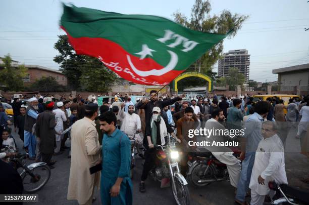 Pakistan Tehreek-e-Insaf party activists and supporters of Pakistan's former Prime Minister Imran Khan celebrate after Supreme Court declared Khan's...