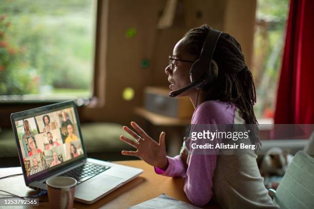 afro-caribbean woman working from home during the covid lockdown - telecommuting stock pictures, royalty-free photos & images