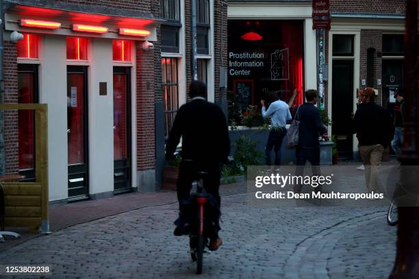 Cyclist rides through the Red Light District as it reopens after the Coronavirus or Covid19 Lockdown on July 01, 2020 in Amsterdam, Netherlands....