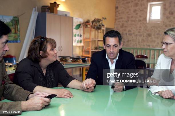 French right-wing presidential candidate of the ruling party Union for a Popular Movement Nicolas Sarkozy speaks with Monia Haddaoui , the mother of...