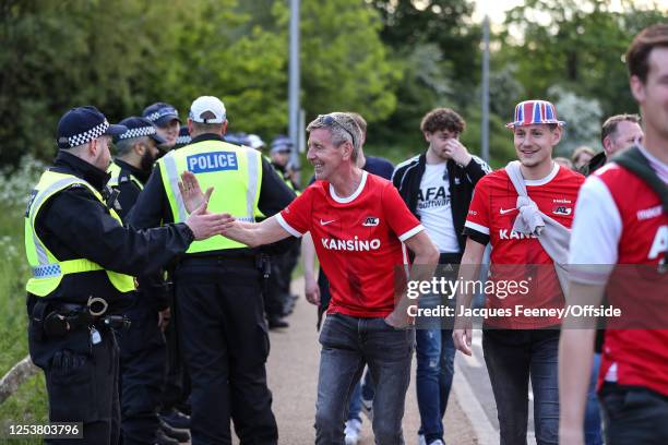 An AZ Alkmaar fan hi-fives the police ahead of the UEFA Europa Conference League semi-final first leg match between West Ham United and AZ Alkmaar at...