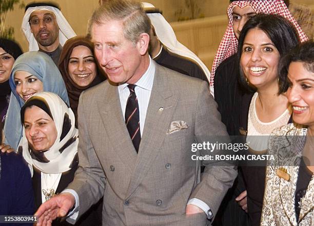 Britain's Prince Charles poses for a group photo with the Kuwait University staff in Kuwait City, 20 February 2007. Prince Charles and his wife...