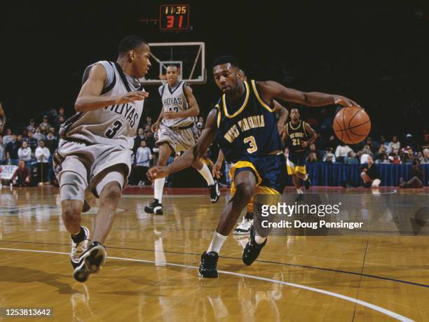 Greg Simpson, Guard for the University of West Virginia Mountaineers and Allen Iverson of the Georgetown University Hoyas during their NCAA Big East...