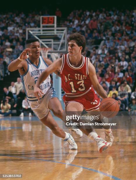 Chris Corchiani, Guard for the North Carolina State University Wolfpack dribbles the ball past, King Rice of the University of North Carolina Tar...