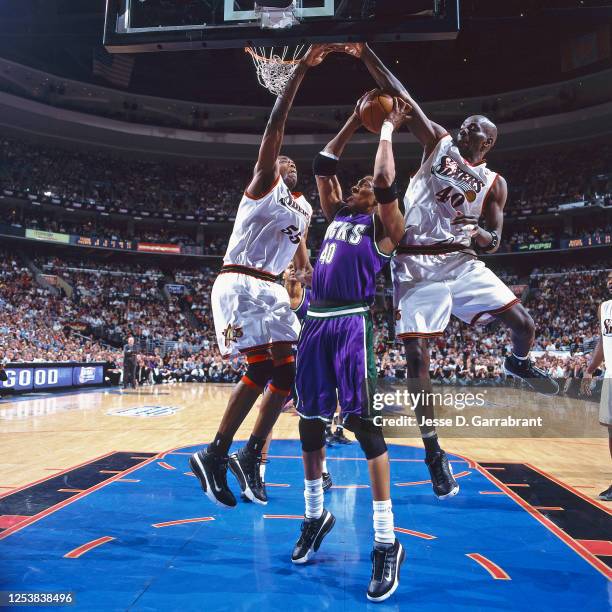 Ervin Johnson of the Milwaukee Bucks looks to shoot against the Dikembe Mutombo and Tyrone Hill of the Philadelphia 76ers in Game one of the 2001...