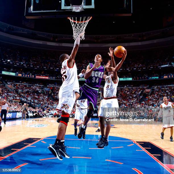 Ray Allen of the Milwaukee Bucks shoots against Dikembe Mutombo of the Philadelphia 76ers in Game two of the 2001 Eastern Conference Finals on May...