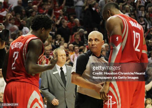 Houston Rockets guard Patrick Beverley and center Dwight Howard talk to referee Ron Garretson during the fourth quarter of game six of the Western...