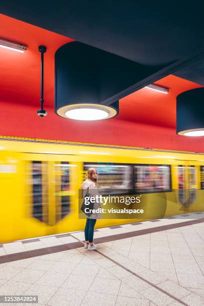 woman standing at railway station - berlin subway stock pictures, royalty-free photos & images