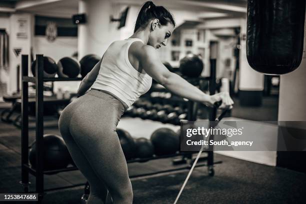 fit woman exercising with resistance band in the gym - elastic band ball stock pictures, royalty-free photos & images