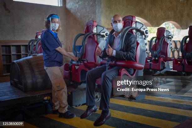 PortAventura World's General Director, Fernando Aldecoa, protected by a mask, gets on the 'Furius Baco' attraction on the day they held an event to...