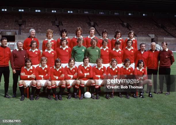 Manchester United line up for a team photograph at Old Trafford in Manchester, England, circa August 1974. Back row : Tommy Cavanagh , Jimmy Nicholl,...