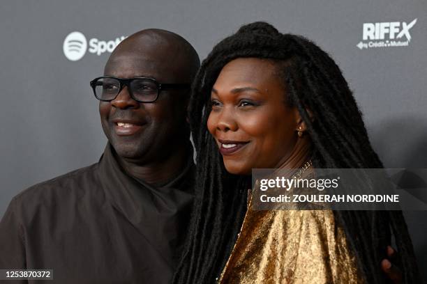 Former French footbal player Lilian Thuram and his wife journalist Kareen Guiock pose during a photo call prior to the first edition of "Les Flammes"...