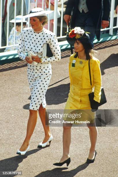 Diana, Princess of Wales, wearing a white dress with black polkadots designed by Victor Edelstein and a matching hat designed by Frederick Fox,...