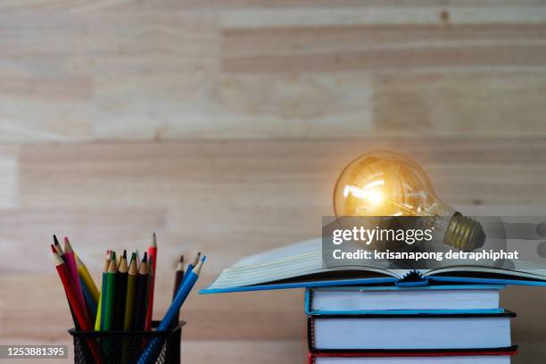 education concept,book and light bulb - school supplies stock pictures, royalty-free photos & images