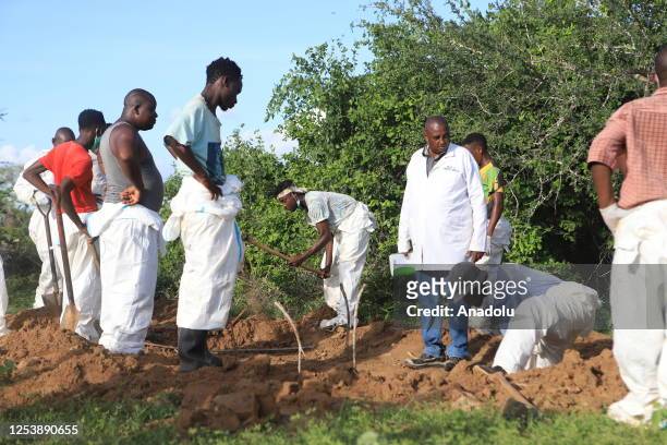 Officials inspect a forested where 145 bodies were found near the Good News International Church in Malindi town of Kilifi, Kenya on May 11, 2023.