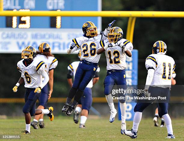 September 16:Gaithersburg's James Waddy , celebrates with is teammate Simba Gwashavamhu after Gwashavamhu's first quarter touchdown during the game...