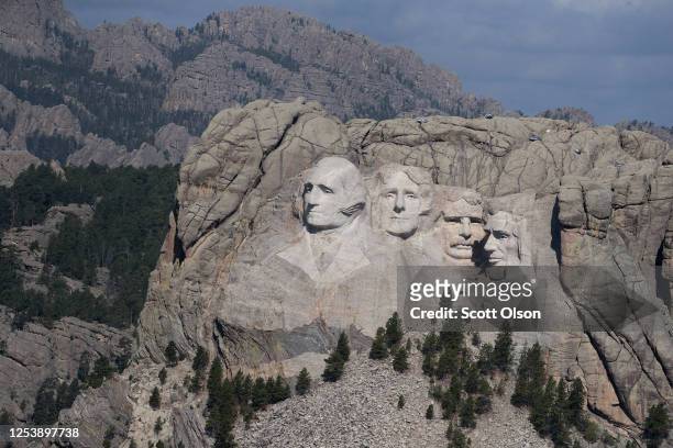 The busts of U.S. Presidents George Washington, Thomas Jefferson, Theodore Roosevelt and Abraham Lincoln tower over the Black Hills at Mount Rushmore...