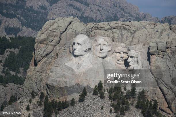 The busts of U.S. Presidents George Washington, Thomas Jefferson, Theodore Roosevelt and Abraham Lincoln tower over the Black Hills at Mount Rushmore...