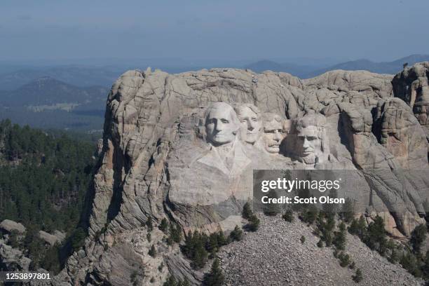 The busts of U.S. Presidents George Washington, Thomas Jefferson, Theodore Roosevelt and Abraham Lincoln tower over the Black Hills at Mount Rushmore...