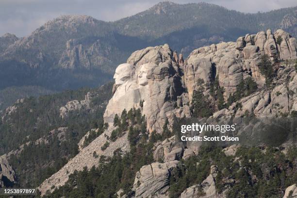 The busts of U.S. Presidents George Washington, Thomas Jefferson look out over the Black Hills at Mount Rushmore National Monument on July 02, 2020...