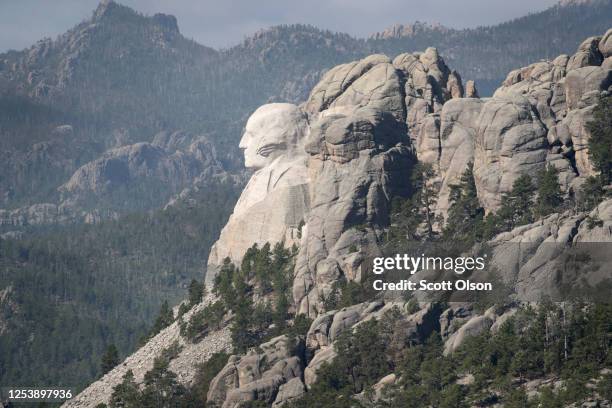 The bust of President George Washington looks out over the Black Hills at Mount Rushmore National Monument on July 02, 2020 near Keystone, South...