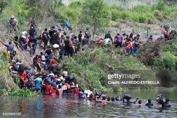 Migrants cross the Rio Grande River as they try to get to the US, as seen from Matamoros, state of Tamaulipas, Mexico, on May 11, 2023. Pandemic-era...