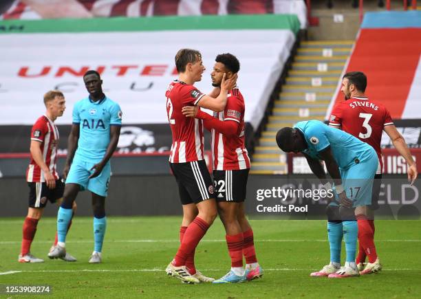 Lys Mousset of Sheffield United celebrates with Sander Berge after scoring his team's second goal as Davinson Sanchez and Moussa Sissoko of Tottenham...