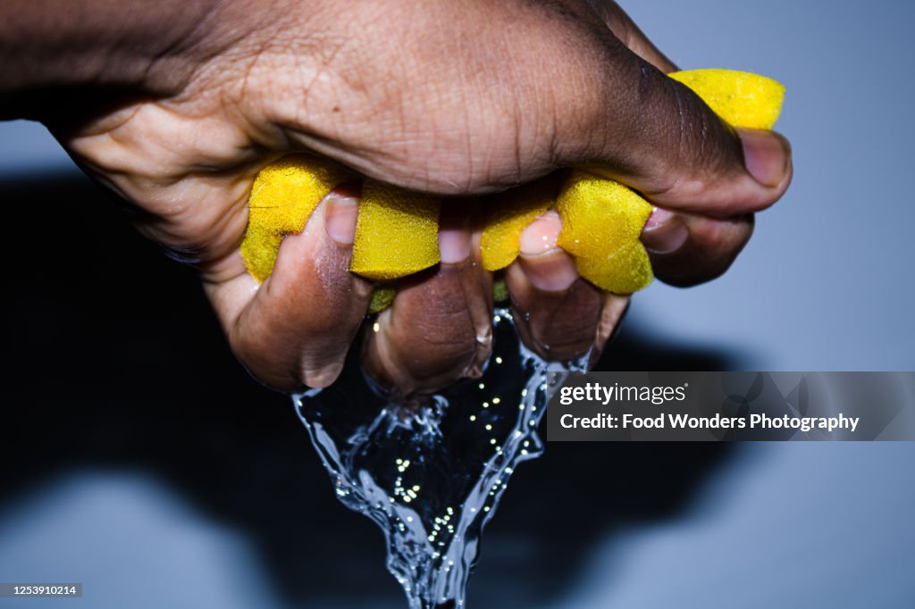 Squeezing a Wet Sponge Background